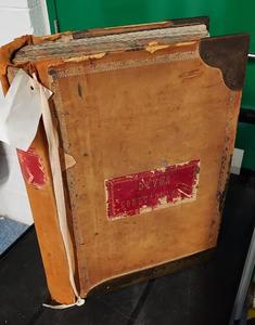 A brown suitcase with a red label