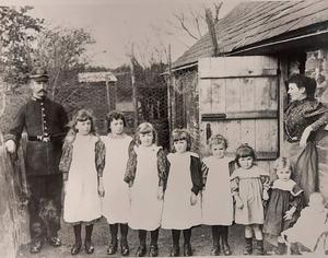 A group of children standing in front of a person and person